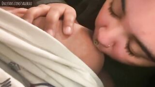 Sucking her large boobs