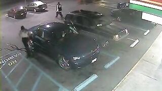 Hopeless ebony woman soaks the parking lot next to the car