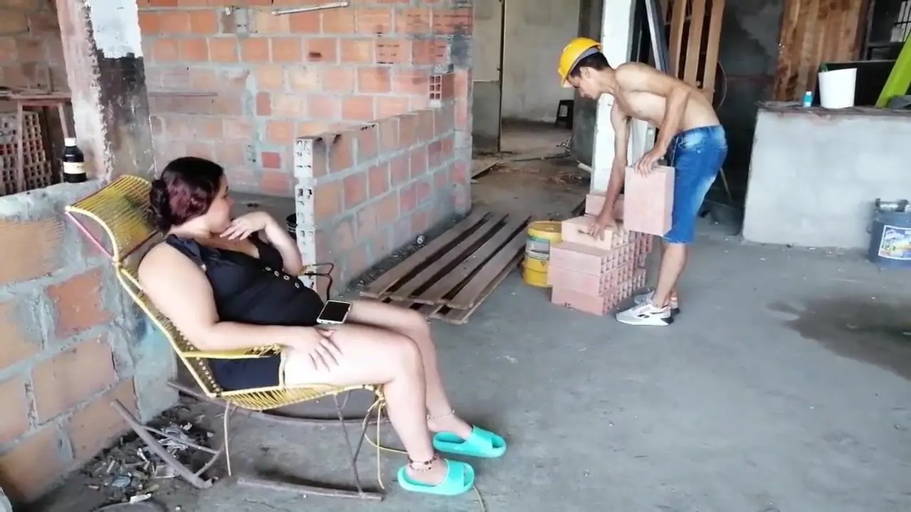 A construction worker stares intenselyRecalling the moment of passionTheir eyes met