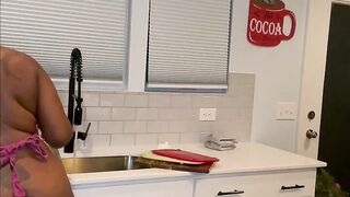 Black with large butt washes dishes in the undressed