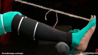 Black serf in green tights Nikki Darling with toes bound to teats gets feet caned then fastened in device on knees butt screwed and whipped by lezdom Claire Adams
