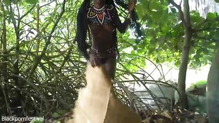 Marvelous tribe gal making traditional jewelery next to a firecamp