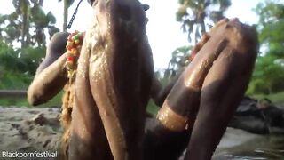 Sexy slim Afro village woman bathing and teasing in a river